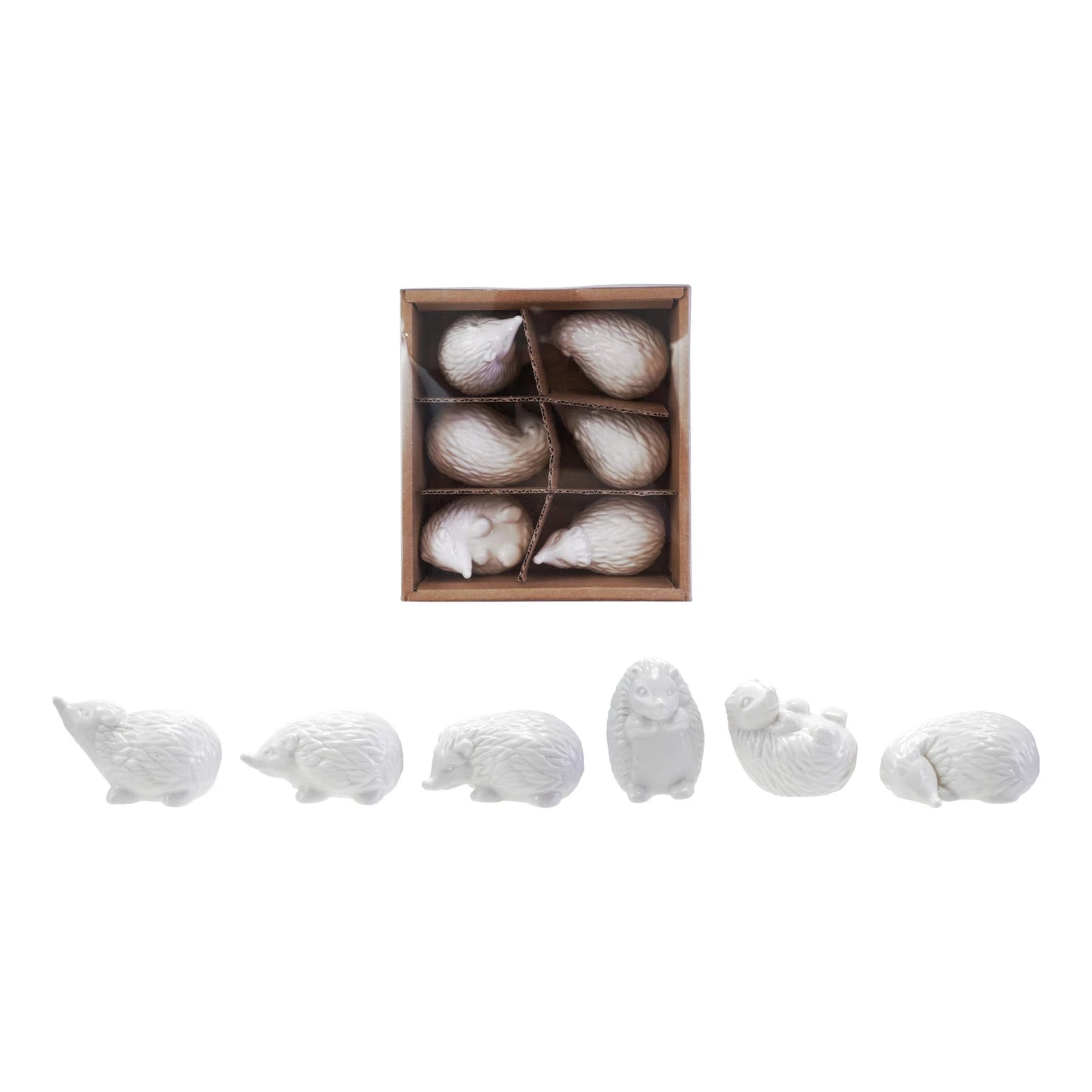 Set of white ceramic hedgehogs in a box and in a row shown on a white background