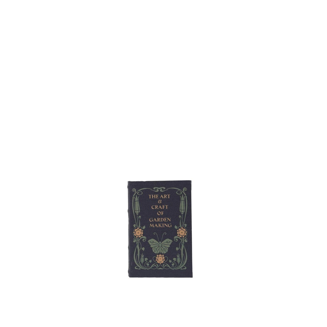 large navy book box with title 'the art and craft of garden making' with image of butterfly and flowers on it