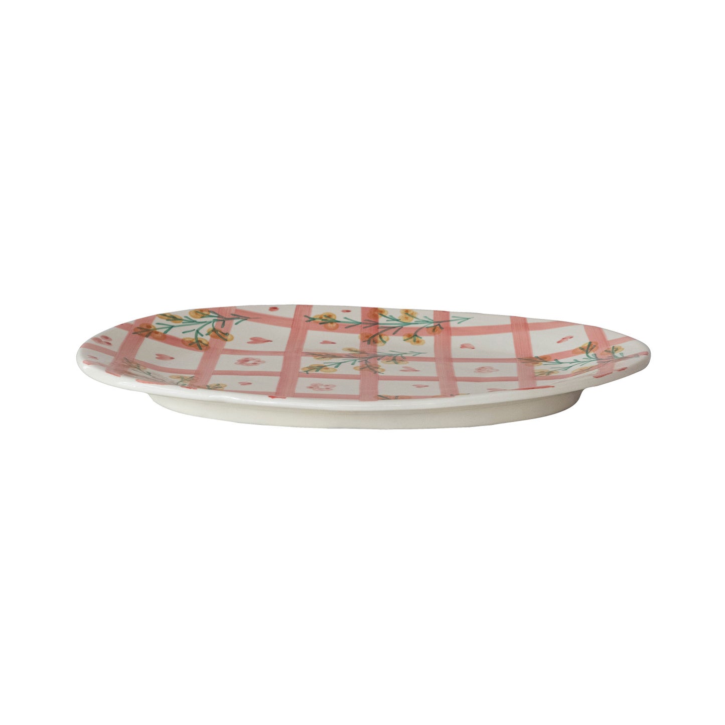 side view of pink plaid and floral platter on a white background