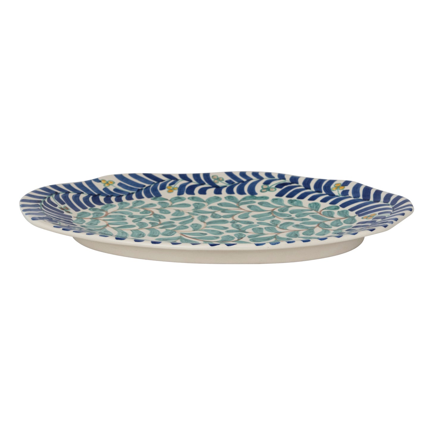 side view of Decorative ceramic platter with blue and green pattern on a white background