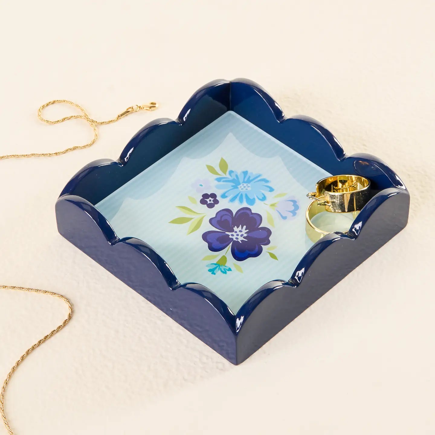 Dainty Navy Floral Scallop Trinket Tray with jewelry in and around it
