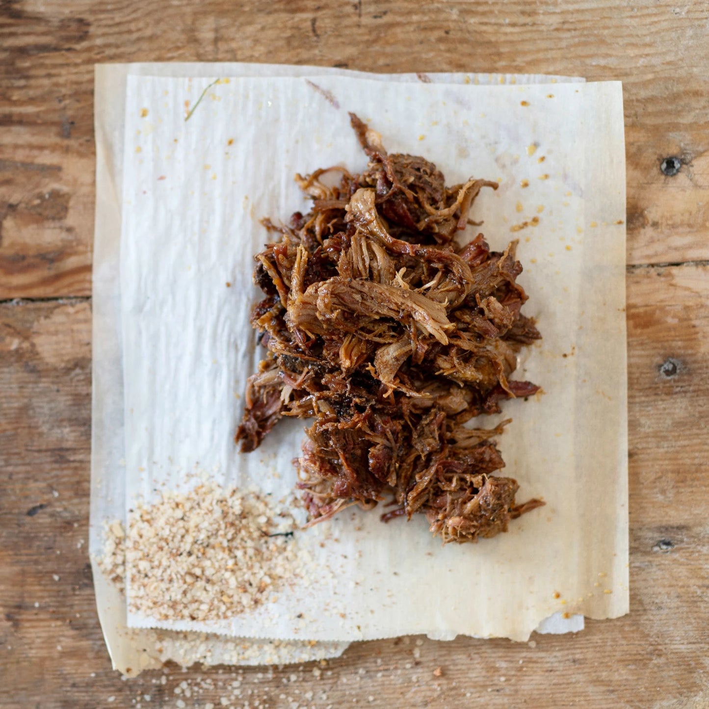 pile of Zesty BBQ Seasoning next to a pile of pulled pork