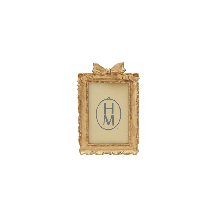 gold rectangle frame with bow on the top of the frame