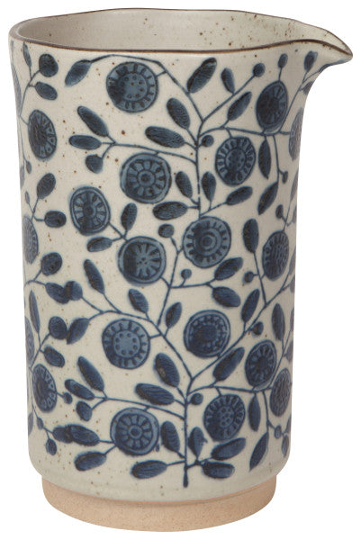 Calendula Element Pitcher with a creamy glaze and blue floral pattern.