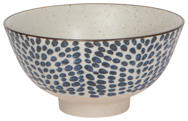stoneware bowl with blue dotted exterior.