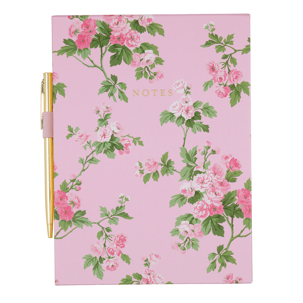 pink Floral notebook with a gold pen on a white background