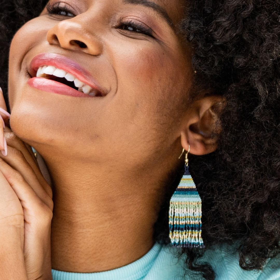 smiling person wearing Lexie Horizontal Stripes Beaded Fringe Earrings