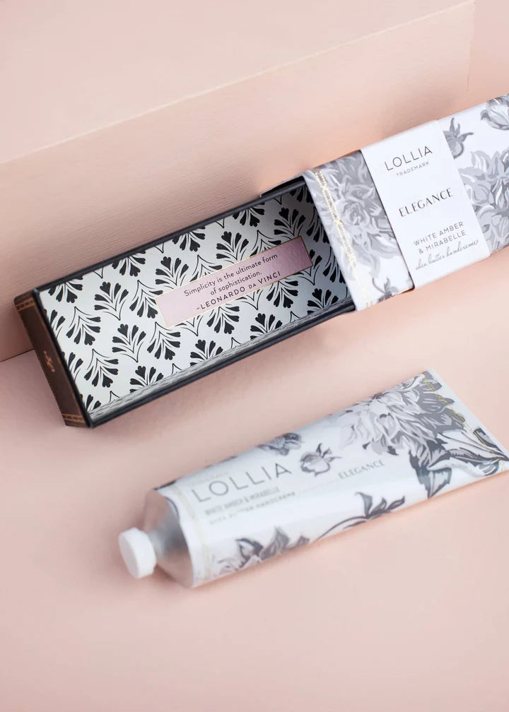 Open box of elegance hand cream set next to a tube of hand cream.