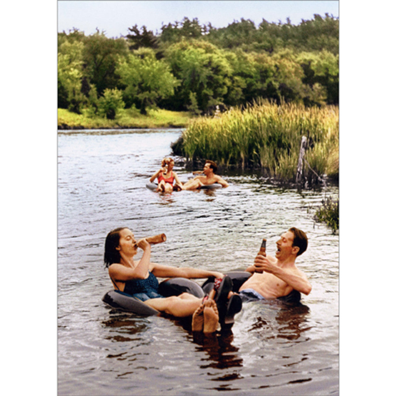 front of card has two sets of couple floating down a river in innertubes while drinking beer