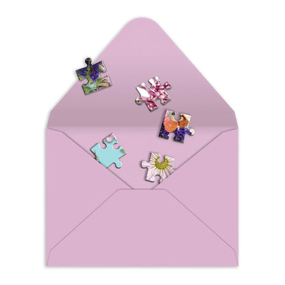 lavender envelope with puzzle pieces being put in it.