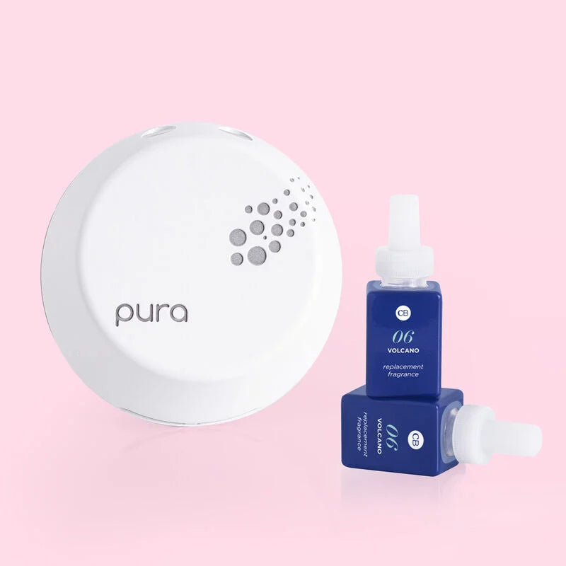 pura plug in device and 2 vials of volcano vials arranged on a pink background.