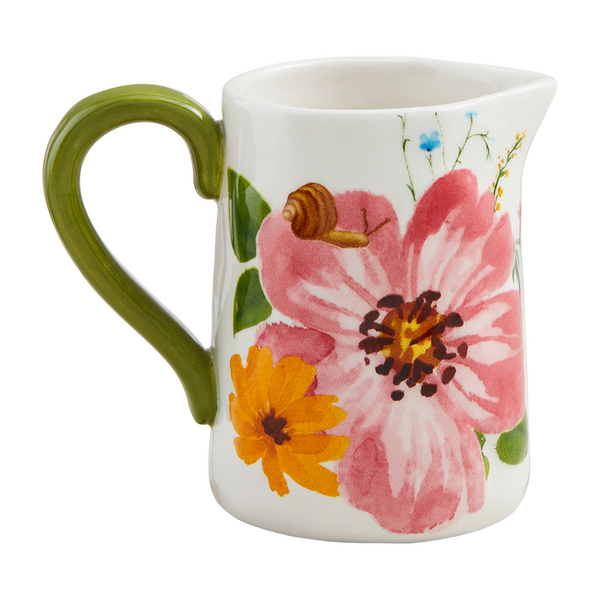 small pitcher vase with a large pink flower, small yellow flower and a snail painted on it.