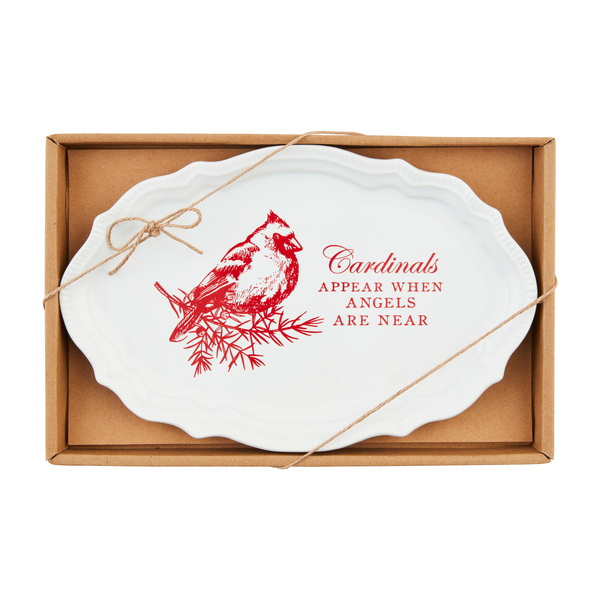 White platter with red design of a cardinal perched on a sprig of greenery and "Cardinals appear when angels are near" printed on it