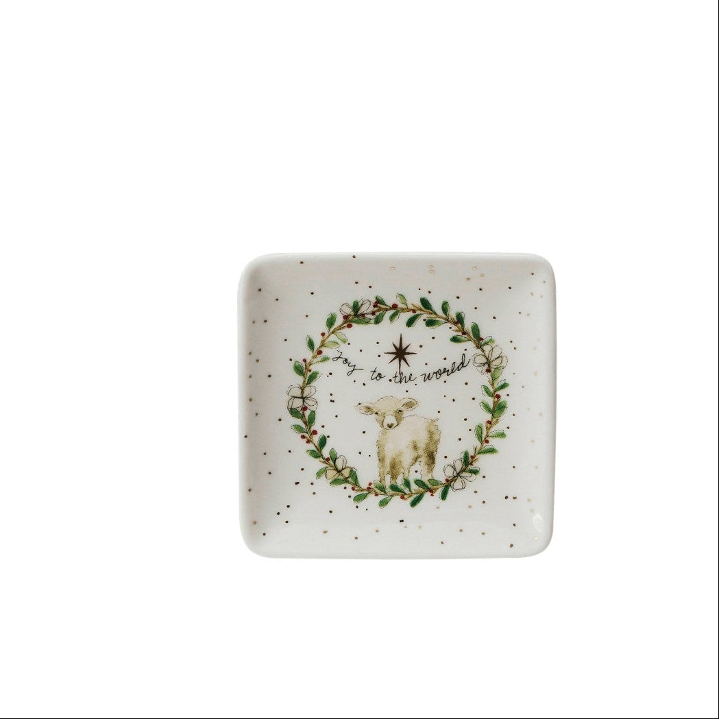 small square dish with image of a greenery wreath around a lamb and text "jo to the world" printed on it