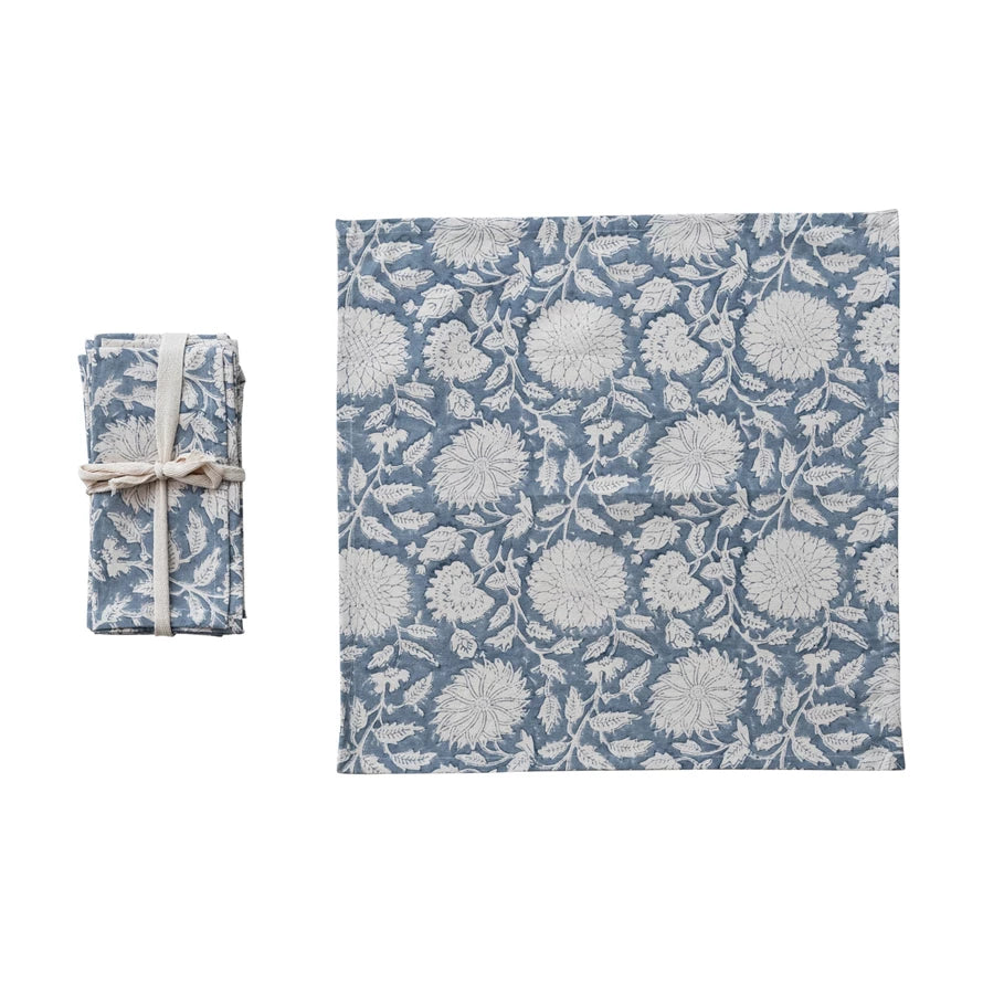 slate blue and linen colored floral block print napkin next to the folded set
