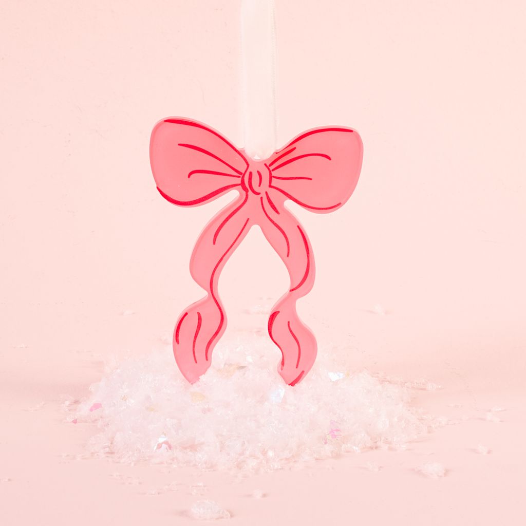 pink flat acrylic bow ornament shown on a pink background