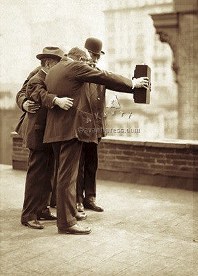 front of card is a photograph of men smiling into an old fashion camera