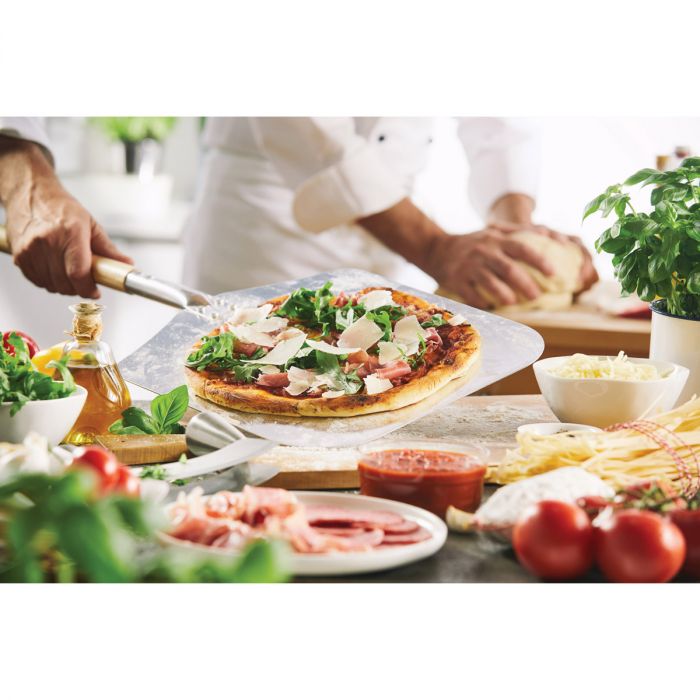 the cousin lorenzos pizza peel with a pizza on it surrounded by spices and vegetables