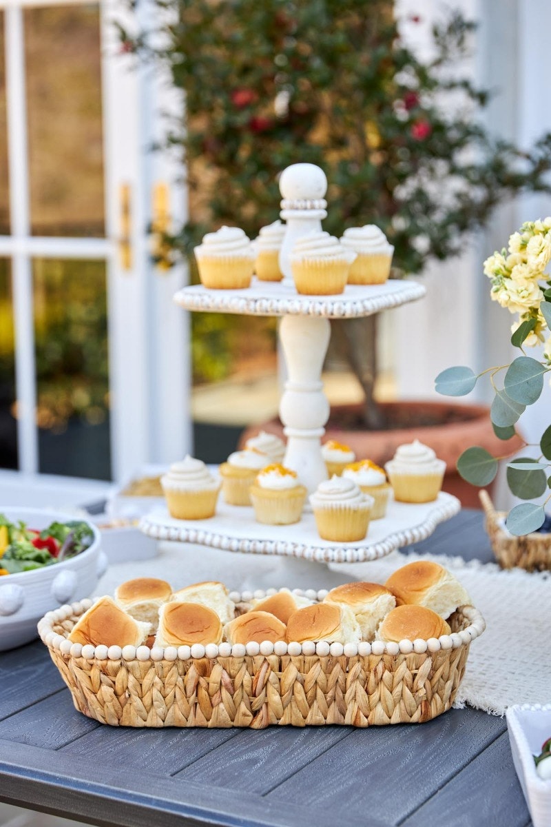 large hyacinth beaded bread basket displayed on a outdoor table setting