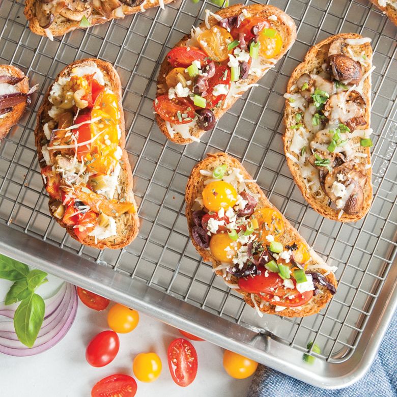 rack in baking tray with focaccia on it.
