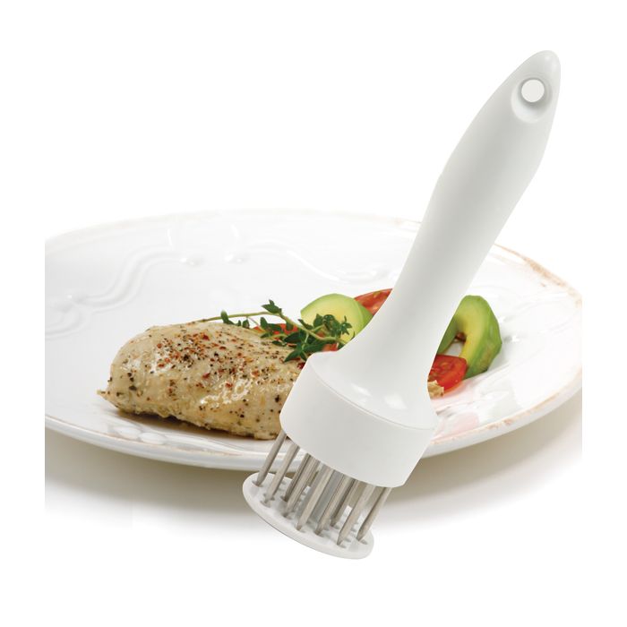 tenderizer with plate of chicken in background.