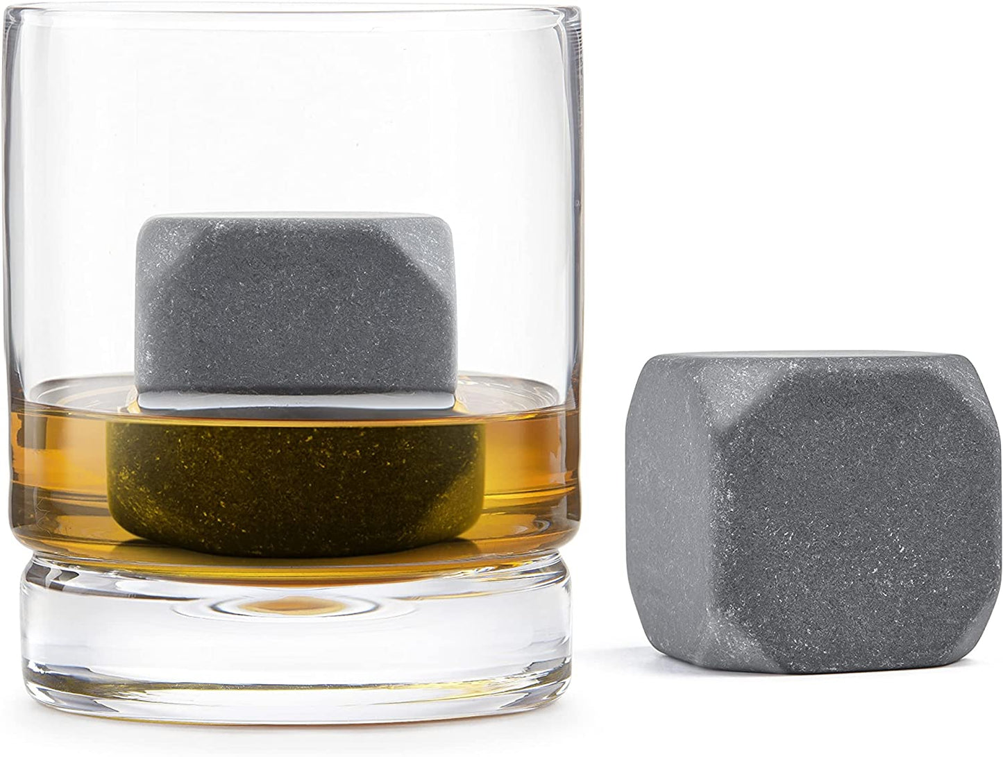 one sculpted chilling stone in a glass with liquid and one sitting beside it on a white background