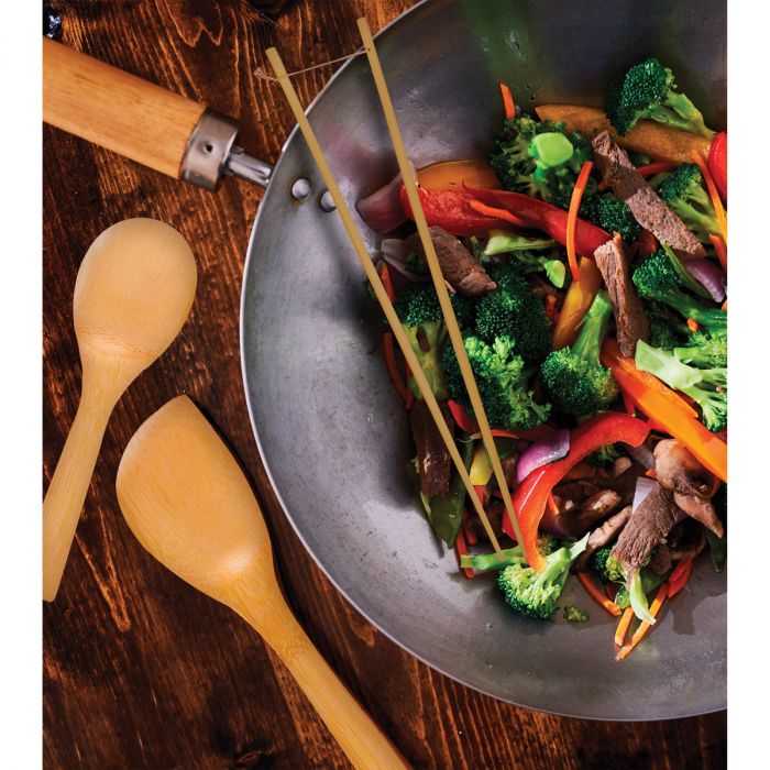 the three piece bamboo tool set displayed with a wok and cooked vegetables on a wooden surface