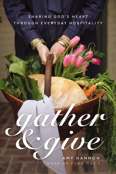 front cover of book has picture of a woman holding a basket filled with bread, flowers, and vegetables, title of book in white, and authors name