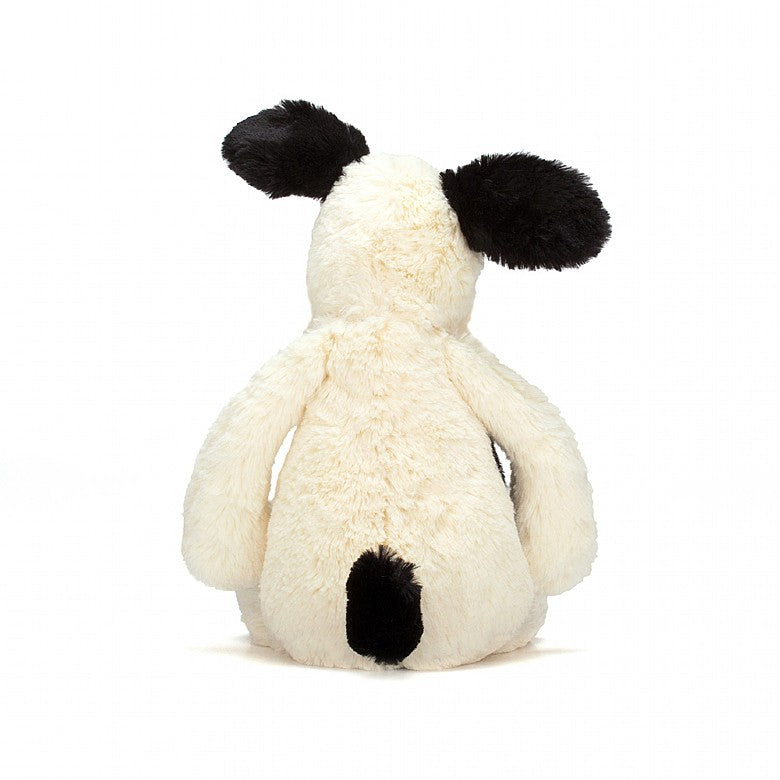 back view of the bashful puppy on a white background