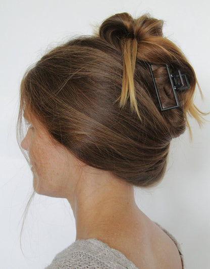 side profile of womans head with a starboard claw clip in her hair against a white background