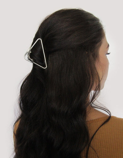 back view of womans head with starboard claw clip in her hair against a white background