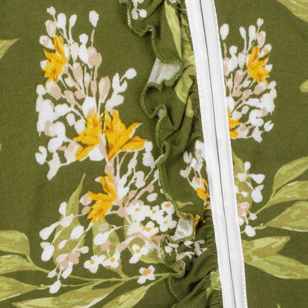 close up view of the ruffle along the zipper of the green floral ruffle footed romper