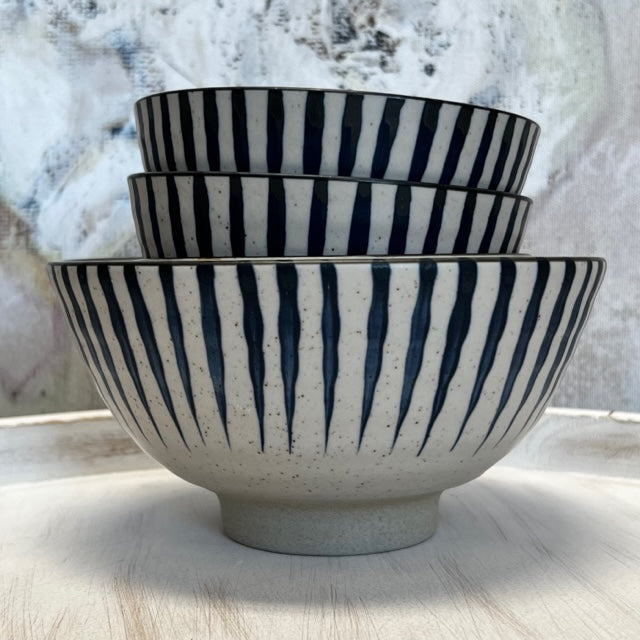 stack of off-white bowls with navy stripes.