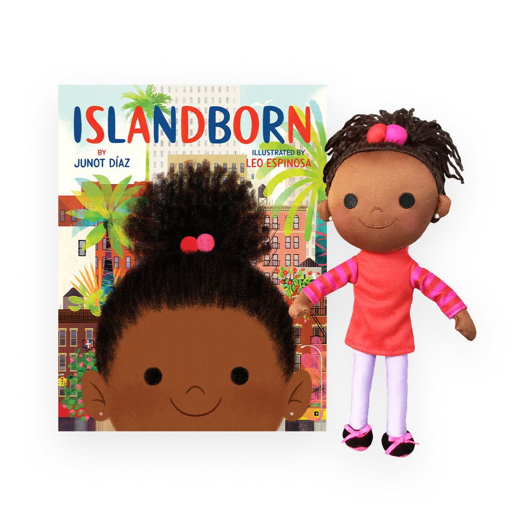 islandborn doll next to the islandborn book on a white background