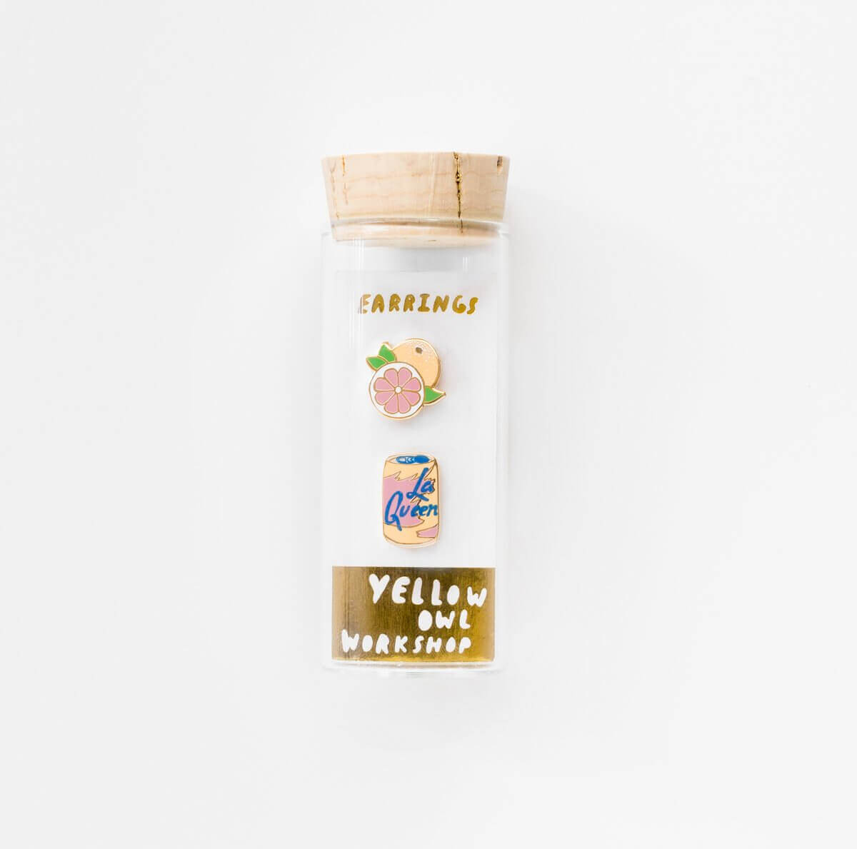 earrings shown in glass vile packaging on white background.