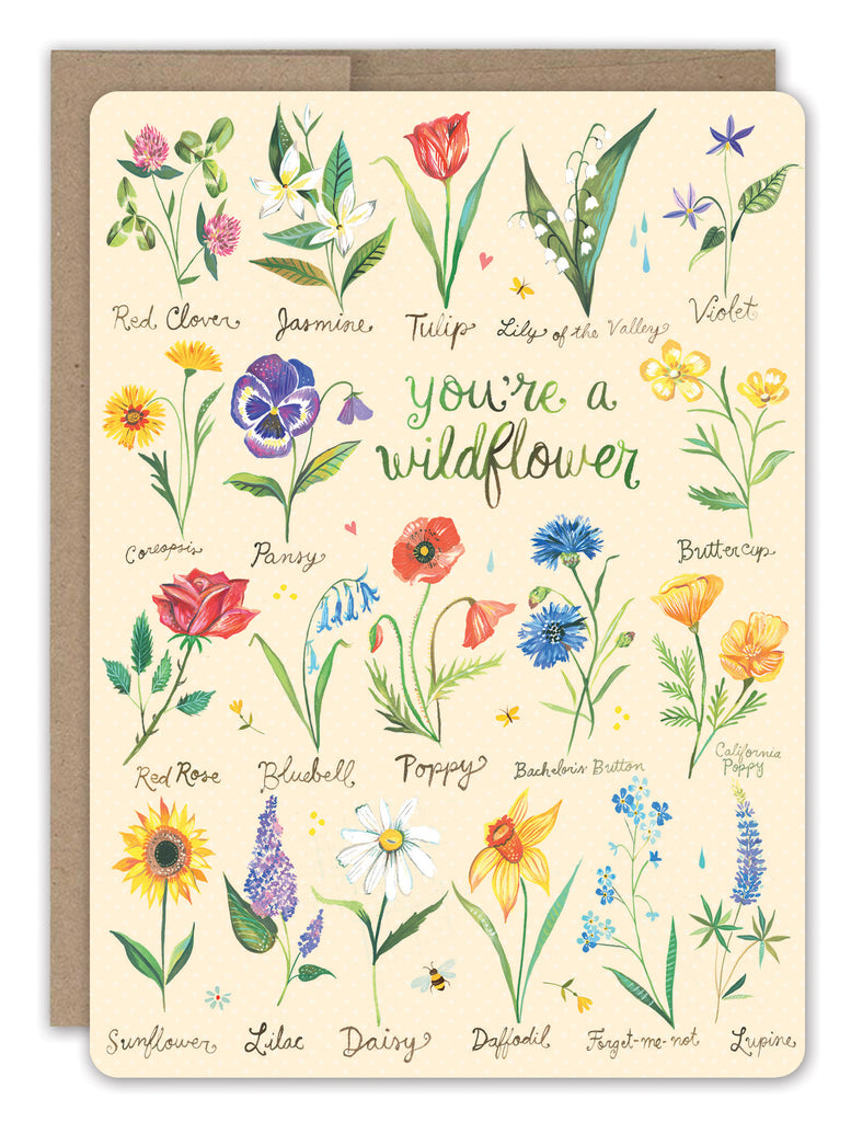 front cover of card is light pink with multiple different types of flowers and text in green listed in the description with a natural envelope behind it on a white background