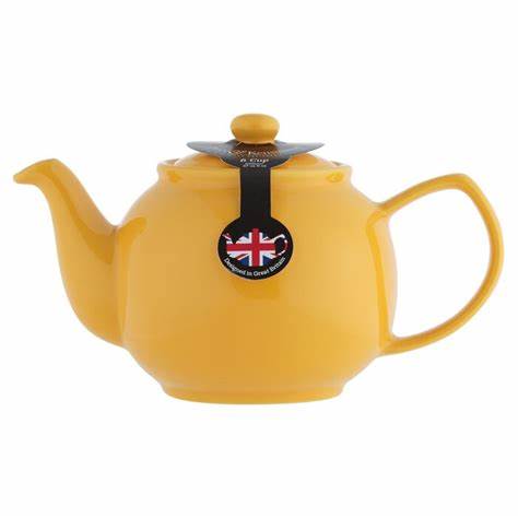 mustard teapot with label on its lid on white background.