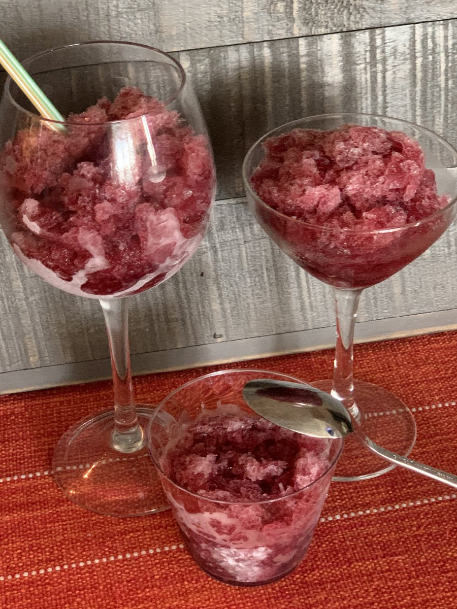 three different style glasses filled with wine time slushie on a rust colored tablecloth