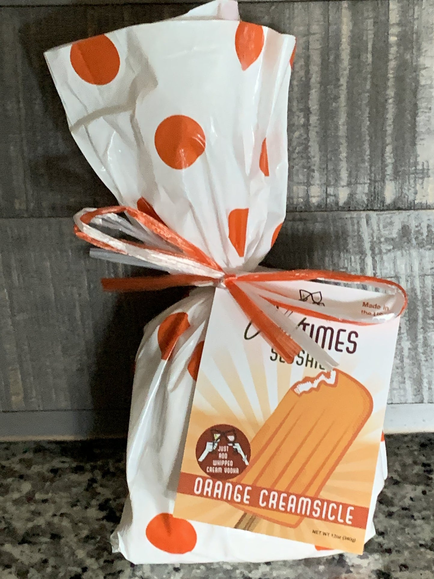 orange creamsicle slushie mix package displayed on a granite countertop