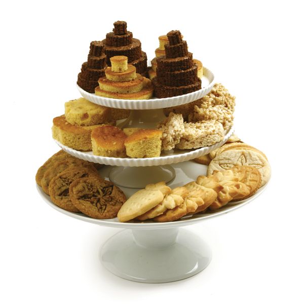 stacked cake plates piled with cookies, cakes, and other treats that have been cut with round cutters.