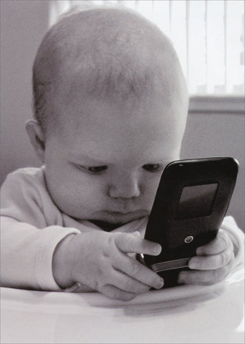 front of card is a black and white photograph of a baby looking at a cell phone
