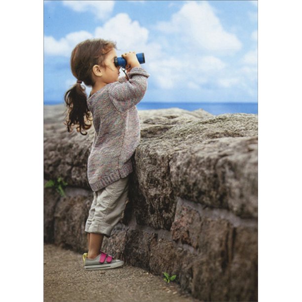 front of card is a photograph of a little girl looking over a rock wall through binaculars 