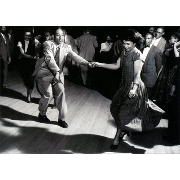 front of card is a photograph is a photograph of a man and woman dancing in the circle of people