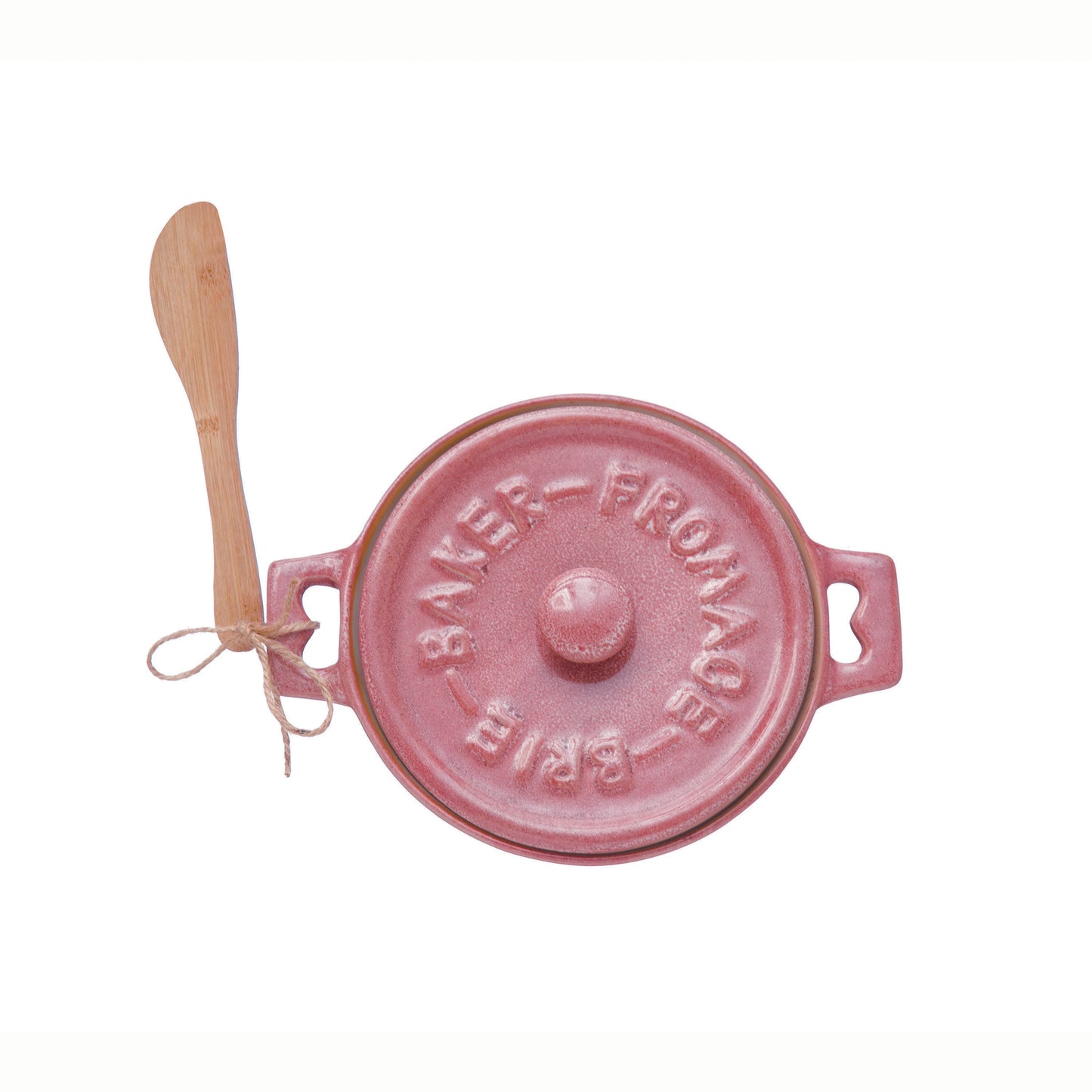 top view of a pink brie baker with wooden spreader tied to the handle on a white background.