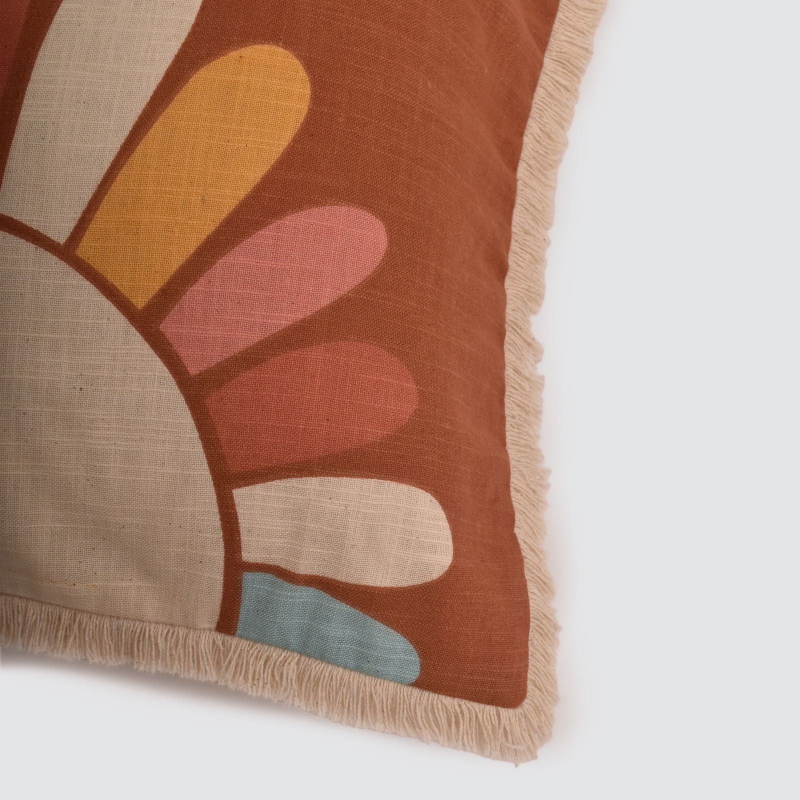 close-up of corner of pillow with sun design.