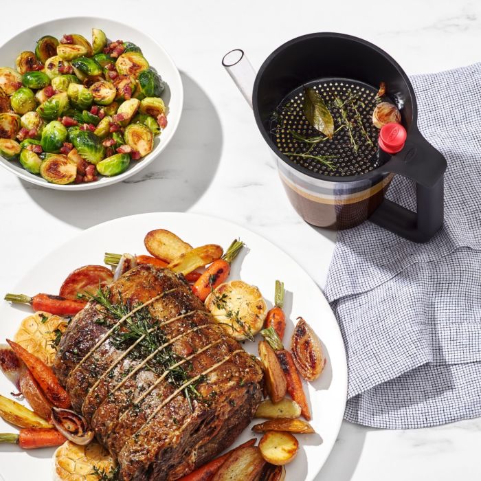 top view of separator showing bits that were strained out set next to cooked meat and veggies.