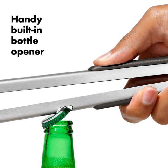 close-up of tong handle showing slot removing a bottle cap from bottle.