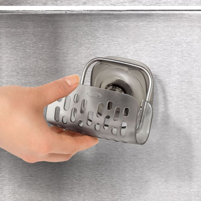 hand placing sponge holder onto suction cup.