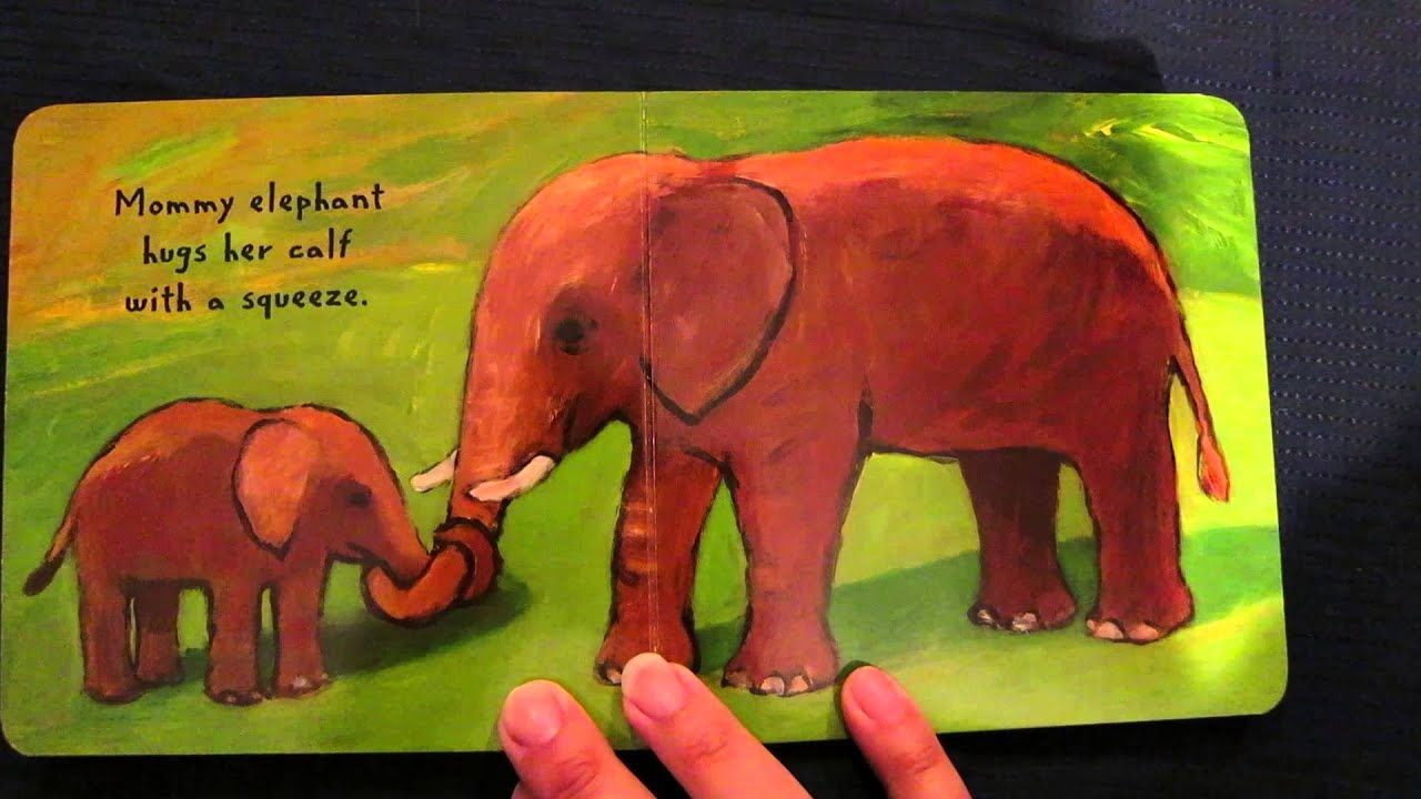 inside view with mommy and baby elephant hugging in the grass