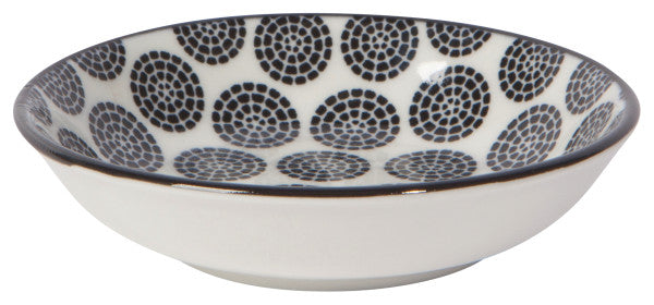 off-white bowl with black circles made of dots.